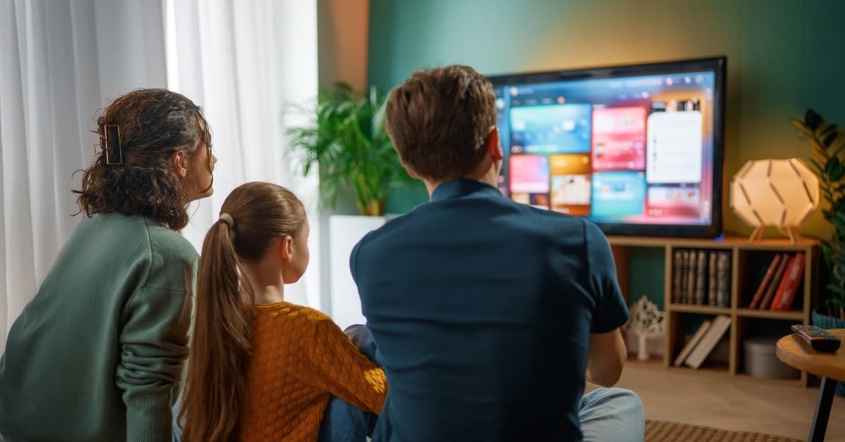 Family watching Delta TV Packages on smart TV with customizable streaming interface