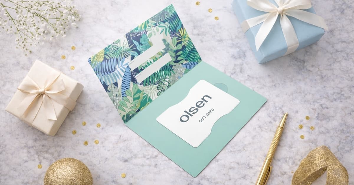 Olsen gift card displayed in elegant packaging with wrapped gifts and stationery