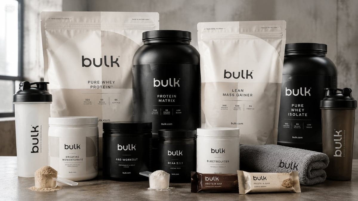 "Bulk sports nutrition supplements including protein powder, creatine, pre-workout, vitamins, and recovery products arranged for fitness training and athletic performance."
